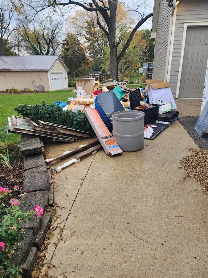 Dumpster being loaded with debris for 12 Yard Dumpster Rental in Manteca